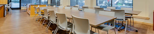 A conference room with a long table and chairs.