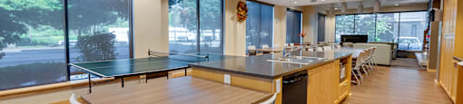 A modern kitchen with a table and chairs.