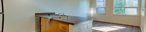A kitchen with wooden cabinets and a black countertop.