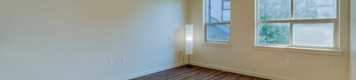 A room with wooden floors and a window.
