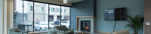 A living room with a fireplace and a flat screen TV.