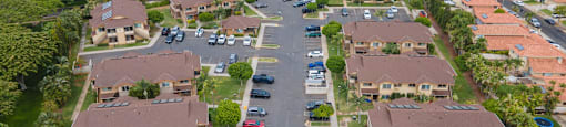 an aerial view of a neighborhood of houses with cars parked