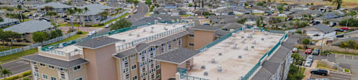 an aerial view of an apartment complex with cars parked in a parking lot