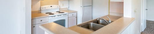 a kitchen with white appliances and a sink