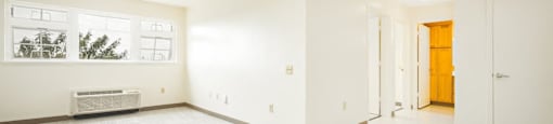 the living room and entrance of an empty house with white walls and flooring