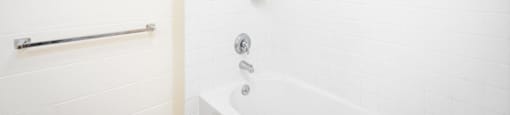 a white bathroom with a shower and a tub
