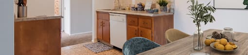 a kitchen with wooden cabinets and a wooden dining table at Bedford Castle, Bedford Heights, Ohio 44146