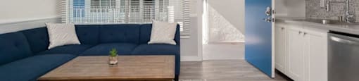a living room with a blue couch and a table