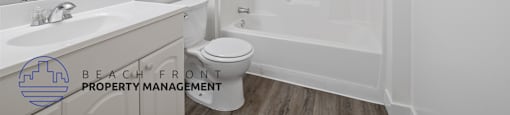 A white bathroom with a toilet, sink, and shower.