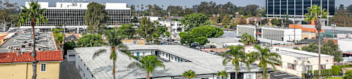 A parking lot with cars and a building in the background.