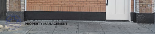 the front of the property management office with a car reflection in the window