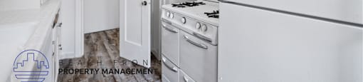 a white kitchen with white appliances and a white refrigerator