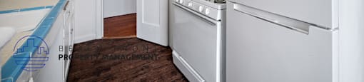 a kitchen with white appliances and white cabinets and a white refrigerator