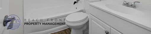 A white bathroom with a toilet, sink, and shower.