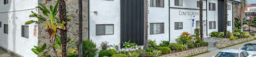 A row of white houses with the word "CONSTELLATION" on the front of the first one.