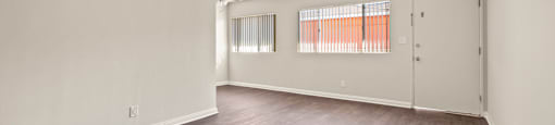 A room with wooden floors and white walls.