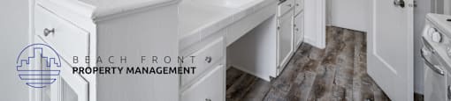a white kitchen with white counters and white cabinets and a white door