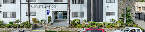 A white building with the words CONSTELLATION on the front and a sign that says BLACK FRONT.