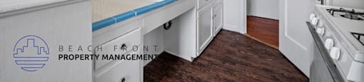 a white kitchen with white cabinets and a blue counter top