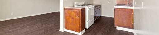 A kitchen with white appliances and wooden cabinets.