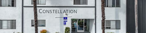 The front of a white building with the word CONSTELLATION on it.