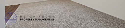 a spacious living room with carpet and a window