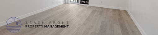 the living room and dining room of an apartment with white walls and wood flooring