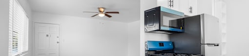 A kitchen area with a stove, oven, microwave, and a fan.
