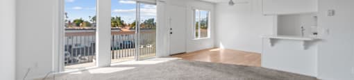 A room with a carpet floor and a logo of Beach Front Property Management on the wall.