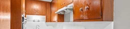 A kitchen with wooden cabinets and a white countertop.