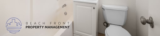 a white bathroom with a toilet and a sink