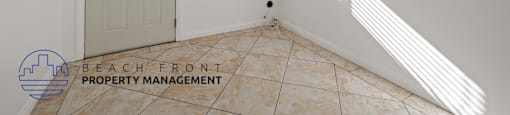 A room with a door, a window, and a tiled floor.