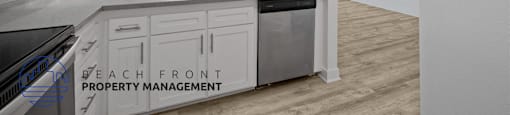 A kitchen with a sink and cabinets with a window in the background.