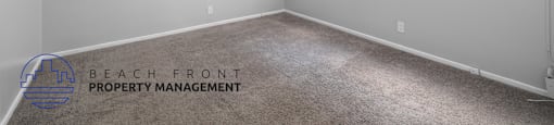 the living room of a house with white walls and carpet
