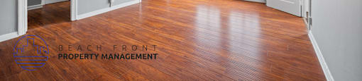an empty living room with hardwood flooring and a window