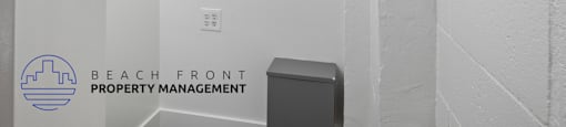 A white wall with a logo that says Beach Front Property Management.