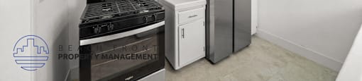 a renovated kitchen with a stove refrigerator and microwave