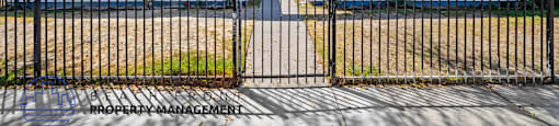 a house with a fence and a gate in front of it