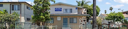 A building with a blue sign in front of it.