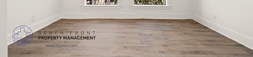 a bedroom with hardwood floors and white walls