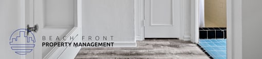 a white door is open to a bathroom and a door to a closet