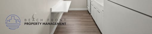 A clean, white kitchen with a washer and dryer built in.