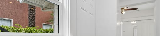 A white door is in a hallway with wood floors.