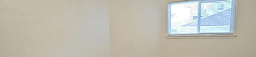 A room with a ceiling fan and carpeted floor.