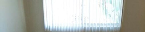 an empty room with a window and a carpet