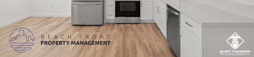 a white kitchen with white cabinets and stainless steel appliances