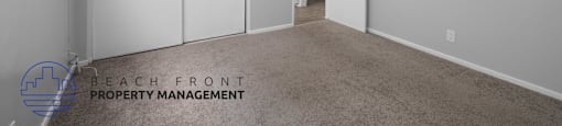 a master bedroom with white closets and a carpeted floor