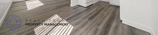 A kitchen with a fan and a logo for Beach Front Property Management.