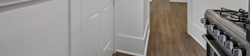 A white hallway with a stove on the right.