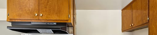 A modern kitchen with a stove top oven and wooden cabinets.